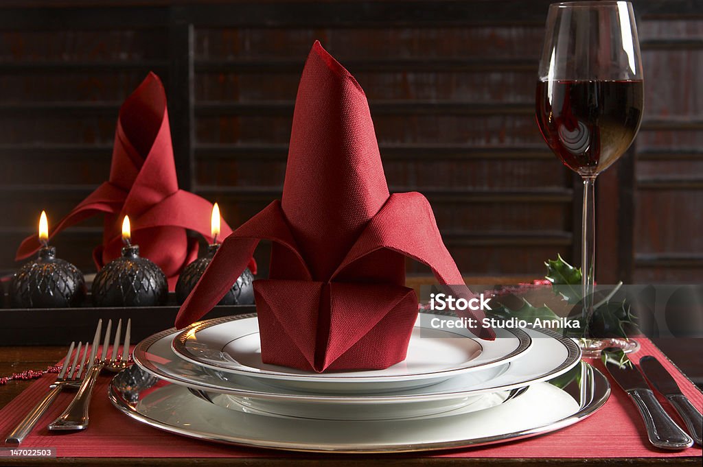Christmas table Christmas dinner table with red placemats and napkins Candle Stock Photo