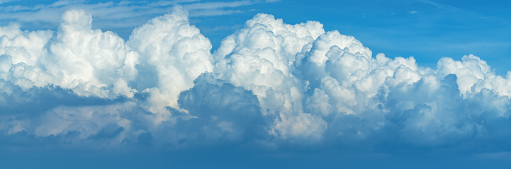 Panoramic image of cumulus clouds at the sky in summer afternoon