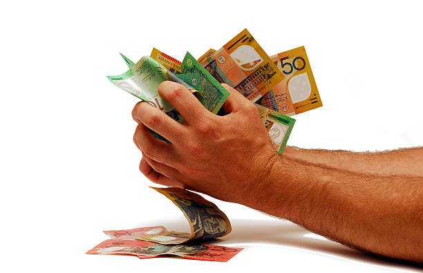 Australian Money in Hands A man's hands holding Australian currency notes greedy corporation stock pictures, royalty-free photos & images