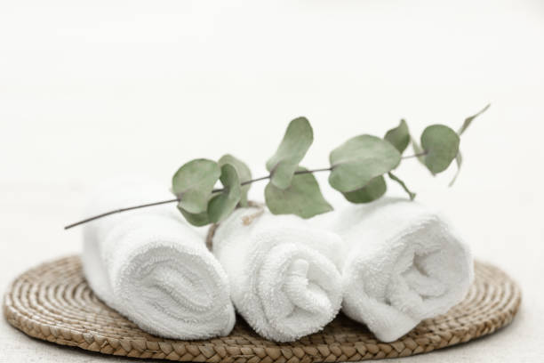 istock Spa composition with white towels and a sprig of eucalyptus. 1470227585