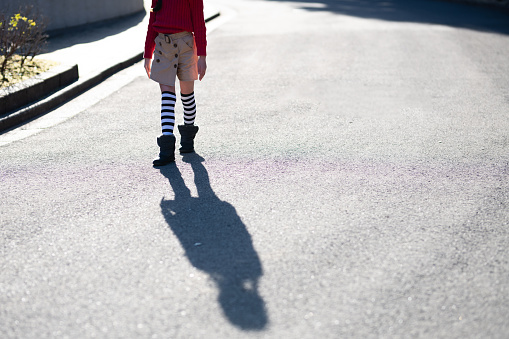 Walking girl's feet and shadows