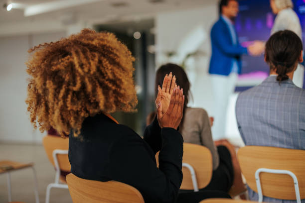 istock Woman applauding in conference. 1470229413