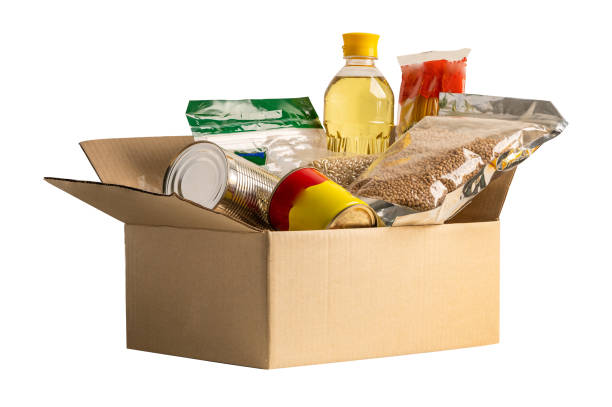 istock Foodstuff for donation isolated on white background with clipping path, storage and delivery. Various food, pasta, cooking oil and canned food in cardboard box. 1470230593