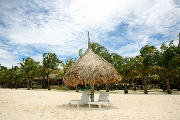 istock chairs with parasol on a beautiful beach 147023131