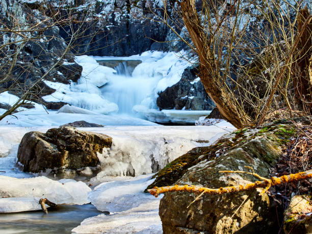 istock Winter and snowy waterfall in the mountains. 1470232339