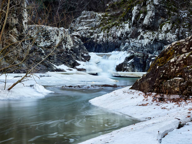 istock Winter and snowy waterfall in the mountains. 1470232399