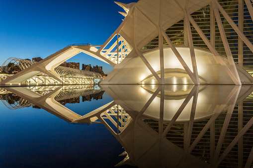 The Science Museum Principe Felipe side building reflected in water. Photo was taken on the 10th of February 2023 in the City of Arts and Sciences complex, Valencia, Spain.