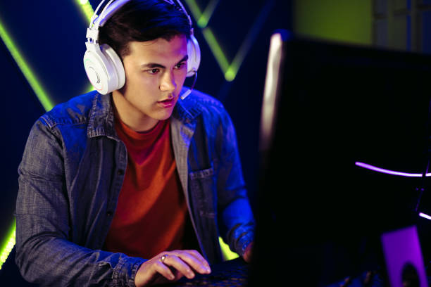 istock Male gamer engaging in a pc video game session with a headset 1470237190
