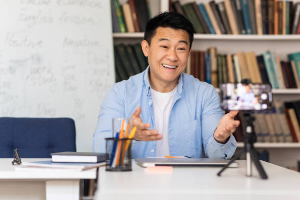 istock Japanese Male Tutor Having Class Via Video Call At Workplace 1470239977