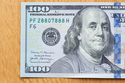 Paper money, here are American banknotes worth a hundred dollars each.