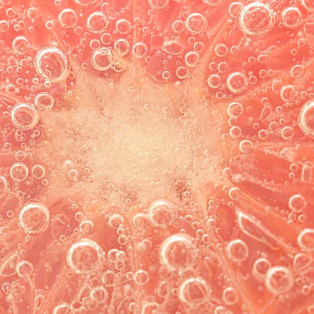 istock Slice of grapefruit in sparkling water. Grapefruit slice covered by bubbles in carbonated water. Grapefruit slice in water with bubbles 1470240101