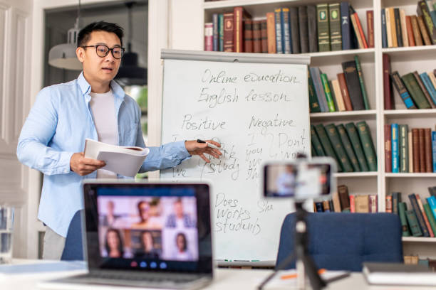 istock Korean Male Teacher Making Group Video Call Teaching Online Indoors 1470240113