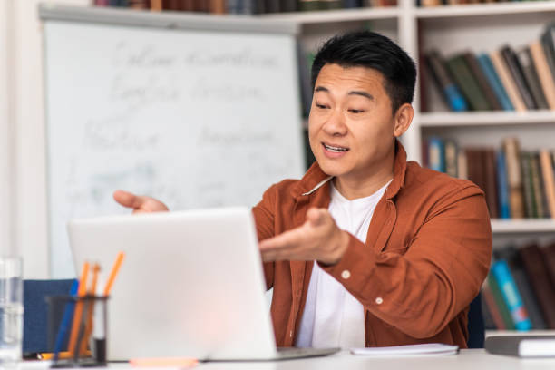 istock Korean Teacher Having Online Lecture Making Video Call In Classroom 1470240123