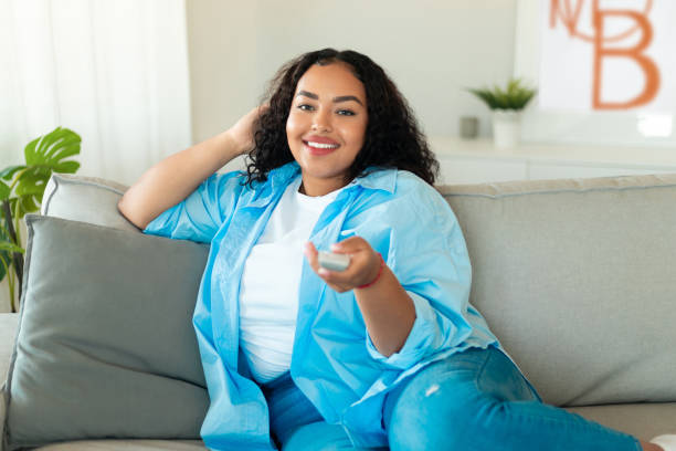 istock African American Lady Watching Television Pointing Remote Controller At Home 1470240907