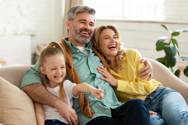istock Middle Aged Parents Hugging Little Daughter Laughing Bonding At Home 1470240979