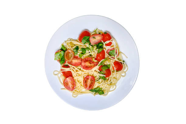 istock Pasta with tomatoes, isolated on a white background. Plate with spaghetti and cherry tomatoes. Pasta decorated with leaves of parsley and cilantro. 1470241240