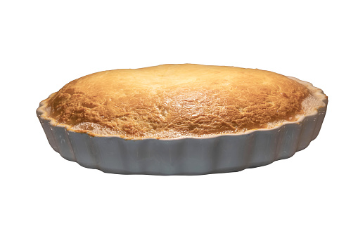 A large pie in a baking dish is in the oven