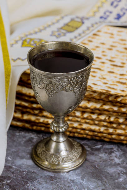 istock A cup of kosher kiddush wine is served with kosher matzah bread during Passover. 1470241636