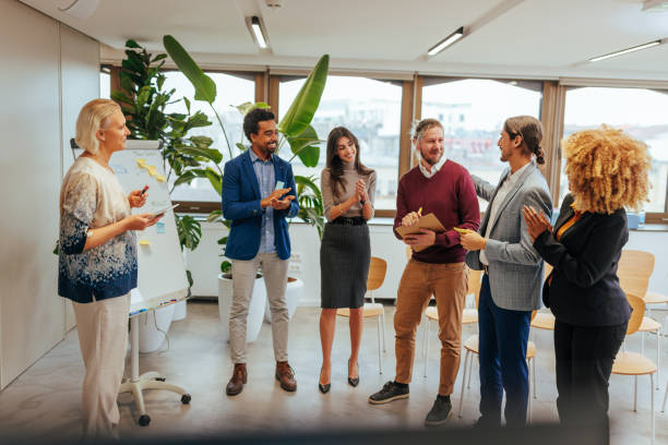 istock Businesspeople congratulate coworker on success. 1470243113