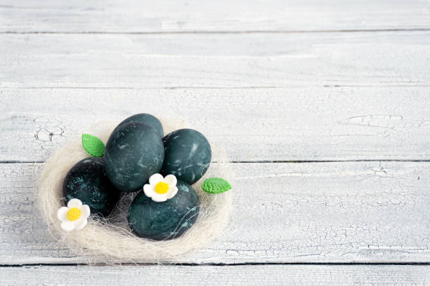 istock Eggs in a decorative white nest are painted for Easter celebration. Festive decor for breakfast 1470246437
