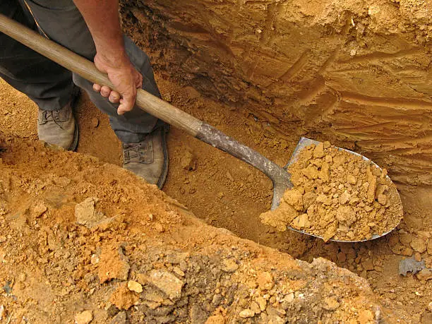 Digging a trench using a shovel