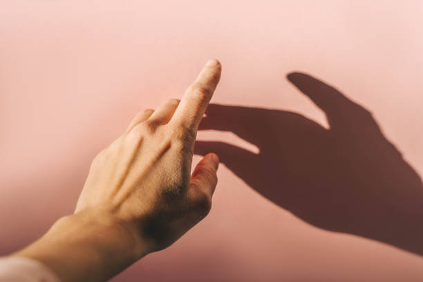 istock Woman's hand on pink background, sunny day. 1470246746