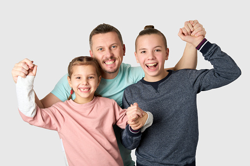 Happy father having fun with his children. Portrait of a father with daughter and son. Happy family portrait on white background, close-up