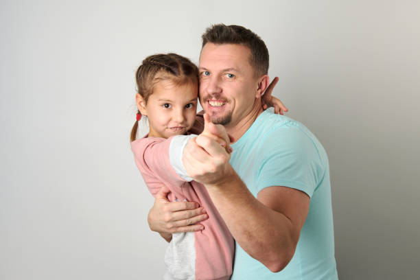istock Playful dad with his child, white background 1470248089