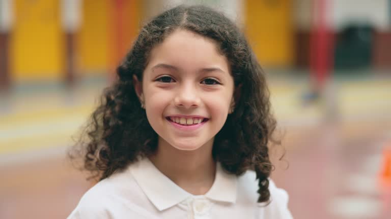 Headshot of cheerful Hispanic schoolgirl