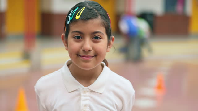 Slow motion headshot of Hispanic schoolgirl