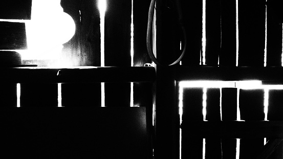 Barn wall, inside view, vertical gaps, strong backlight