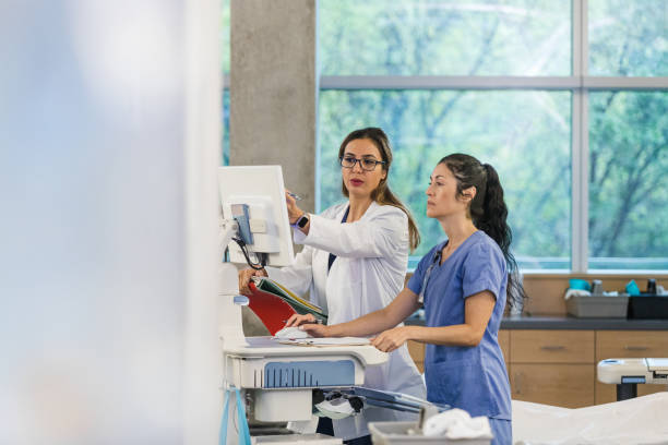 istock Hospital trainer stands with the intern at the computer 1470253293