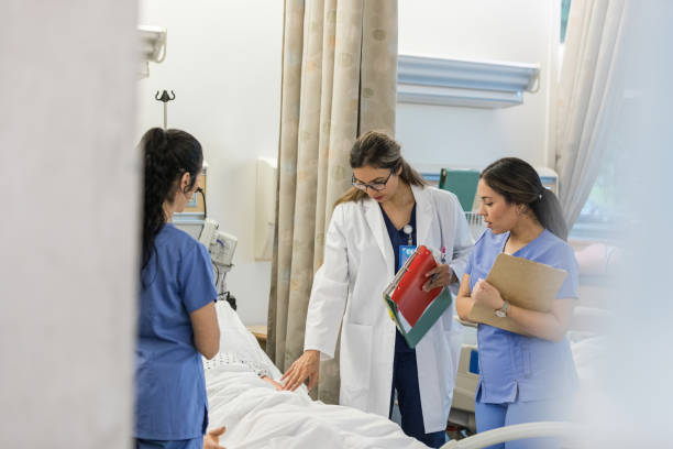 istock Hospital professor stands bedside with the two nurses to teach 1470253294