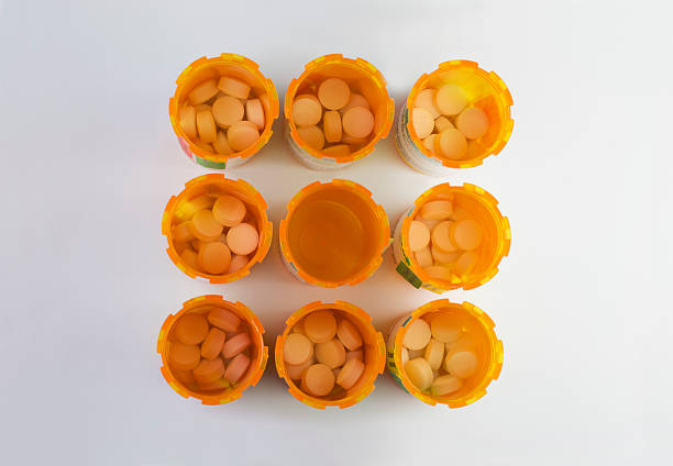 Medicine bottles arranged in a grid stock photo