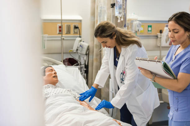 istock Hospital trainer examines the mannequin while the intern takes notes 1470253324