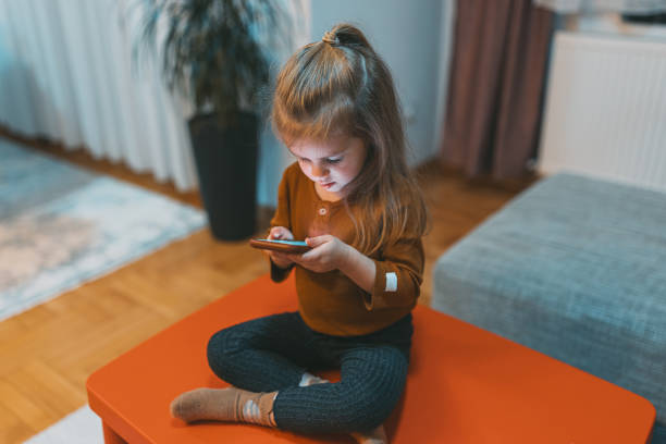 istock The little girl develops her imagination with the phone 1470253598