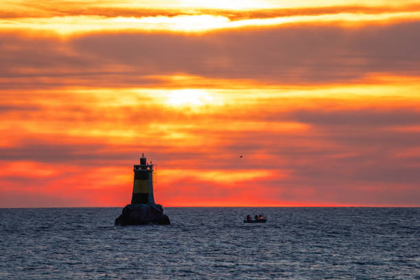istock Boat and lighthouse, beautiful sea sunrise 1470253818