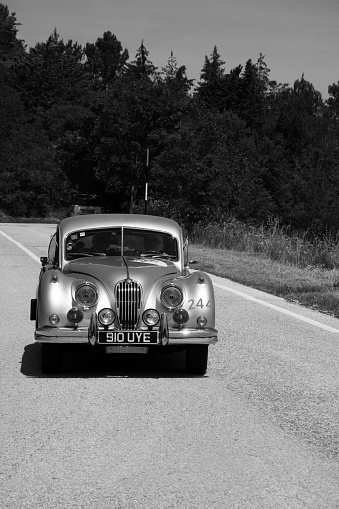 1939 Lagonda V12 tourer driving on a country road. The Lagonda V12 is a car with various body styles produced by the British Lagonda car maker from 1938 to 1940. The car is doing a demonstration drive during the 2017 Classic Days event at Schloss Dyck.