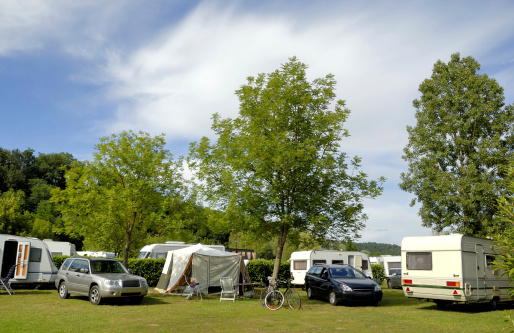 Camping in France with caravans between trees