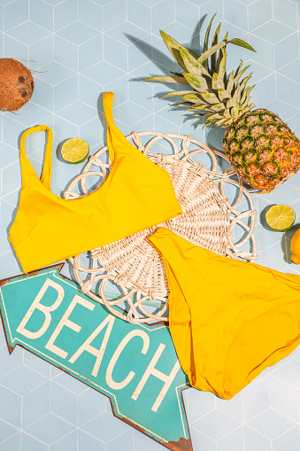 Yellow bikini with tropical decorations and beach sign