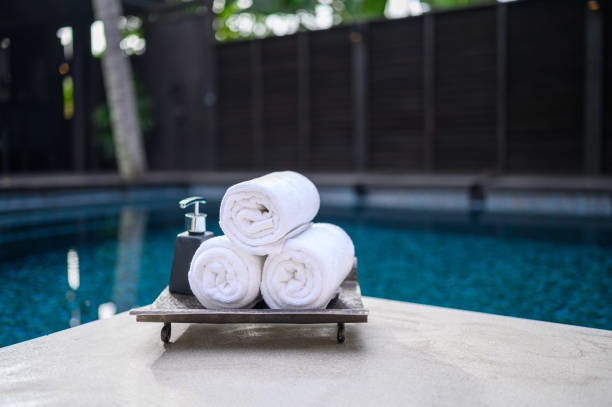 istock Concept Spa : Spa set Towels with bottle cream pump Placed by the pool 1470257827