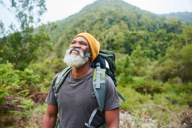 istock Mature man looking at the view during a hike in lush hills 1470259611