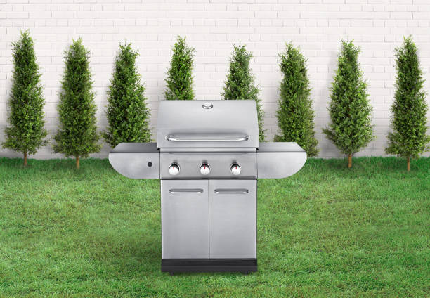istock BBQ grill in a backyard with green grass and brick fence 1470259783