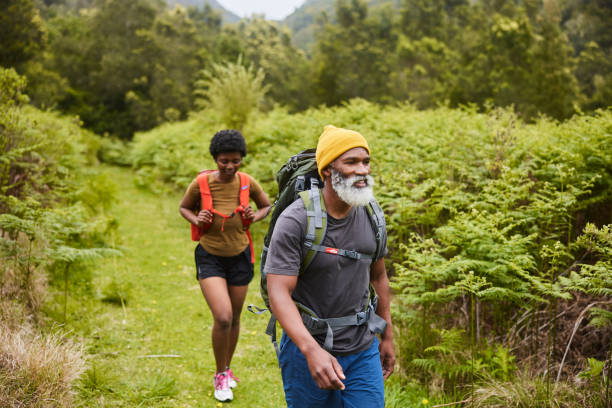 istock Couple hiking together along a path through lush foliage 1470260274