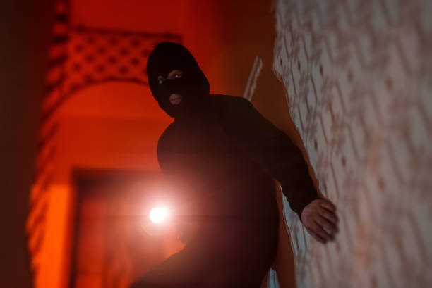 istock Thief in a balaclava at night in the house. 1470261152