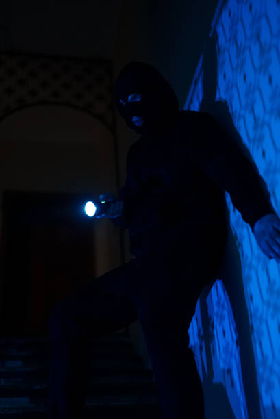 istock Thief in a balaclava at night in the house. 1470261155