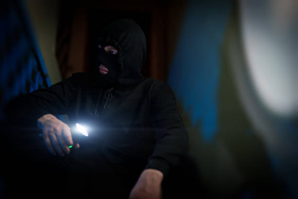 istock Portrait of thief in balaclava with a flashlight. 1470261168