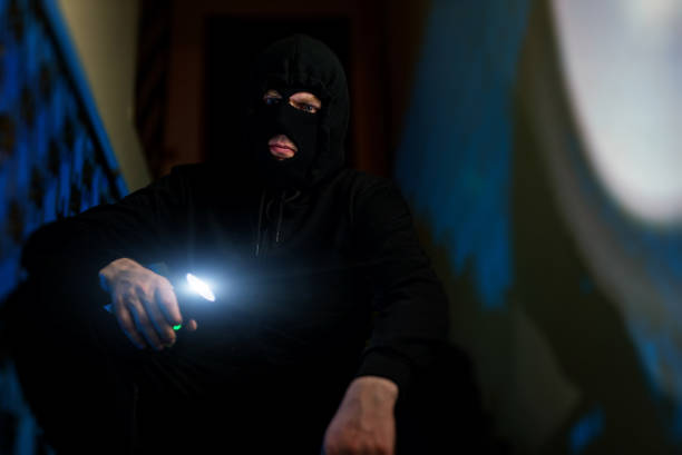istock Portrait of thief in balaclava with a flashlight. 1470261169