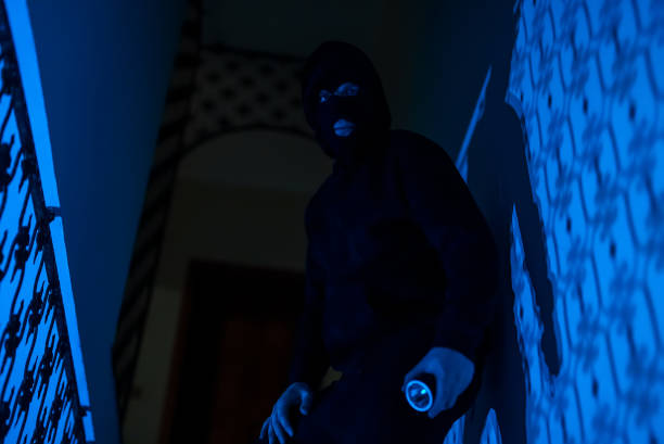 istock Thief in a balaclava at night in the house. 1470261170