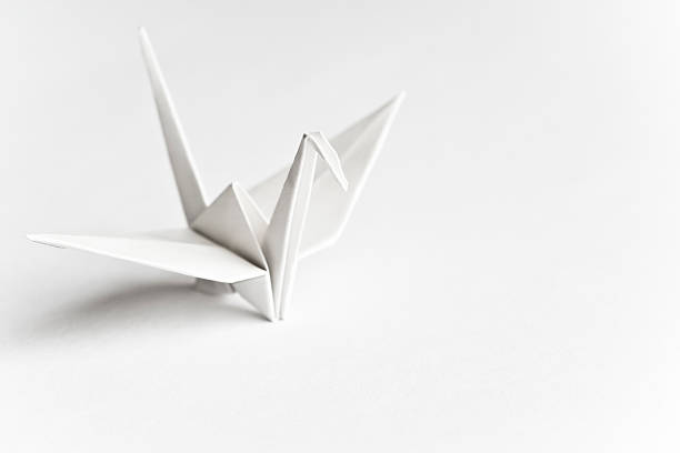 Lonely An origami bird on a white background origami stock pictures, royalty-free photos & images